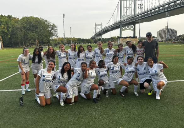 A photo of the girls soccer team after winning the game.