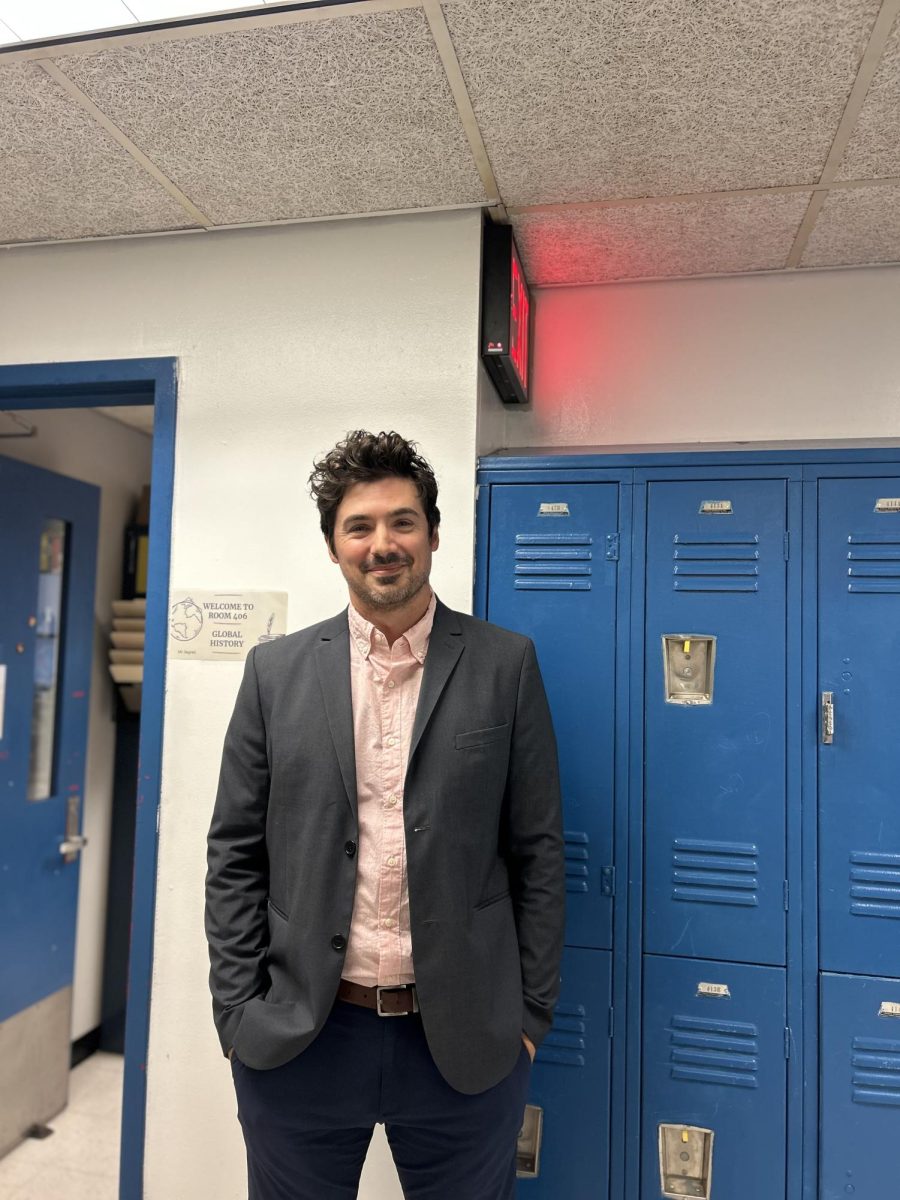 Mr. Segreti poses outside his classroom