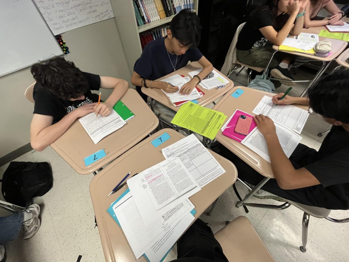 Freshmen work on an assignment in a table group.