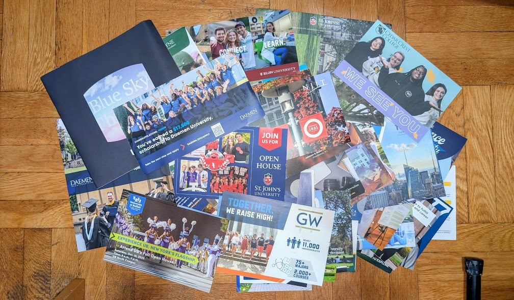 A large pile of college mail scattered across the floor.